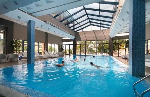a group of people swimming in a swimming pool at Apartment - Studio Cucetno in Sandanski