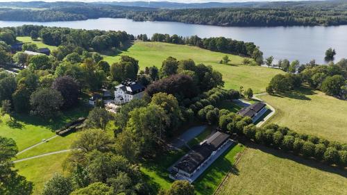 an aerial view of a mansion on the shore of a lake at Baldersnäs Herrgård in Dals Långed