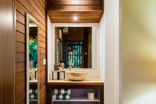 a bathroom with a sink and a mirror at Yeh Pulu House in Ubud