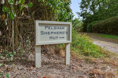 a sign that says pelham shepherds hut on a road at Pelsham View in Peasmarsh