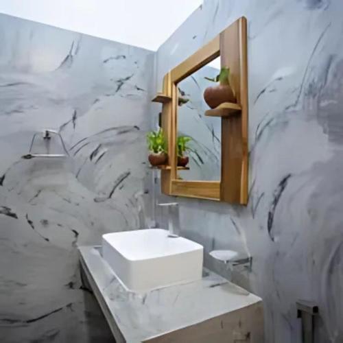 a bathroom with a sink and a mirror at MJ Haven Point in Ahangama