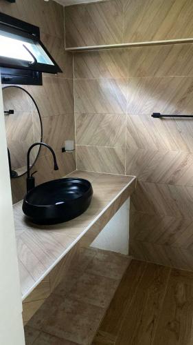 a bathroom with a black sink on a counter at Villa oasis, Résidence Nianing in Nianing