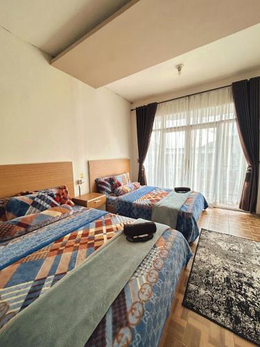 Ένα ή περισσότερα κρεβάτια σε δωμάτιο στο Homestay Lidah Buaya 3 Syariah