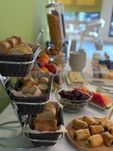 a table with baskets of pastries and other foods at Hotel Spa Olive in Mostar