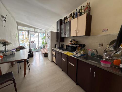 a kitchen with a sink and a table in it at Foxy Forest in Tbilisi City