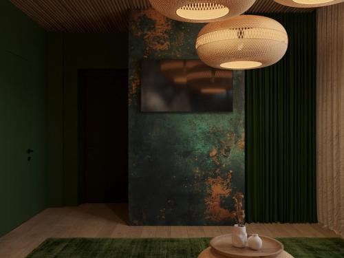 a room with a green wall with a table and lights at Stara Pravda Hotel - Vykrutasy in Bukovel