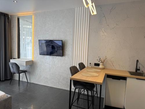 a kitchen with a table and chairs in a room at Apartment with terrace sea view in Odesa