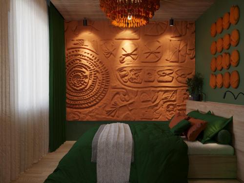 a bedroom with a wall with a bed and a chandelier at Stara Pravda Hotel - Vykrutasy in Bukovel