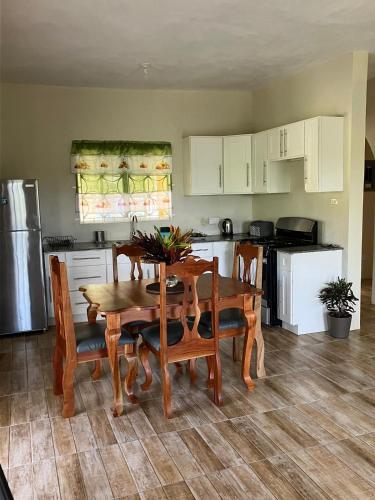 a kitchen with a table and chairs and a kitchen with white cabinets at A Caribbean Oasis 