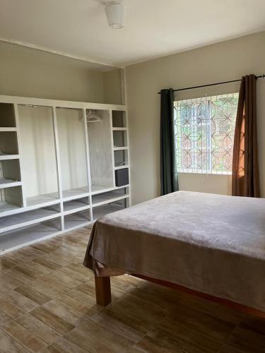 a bedroom with a bed and a window at A Caribbean Oasis 