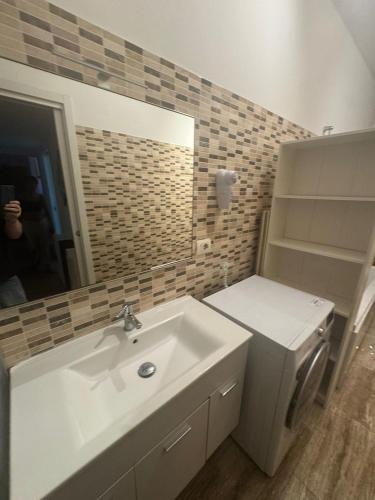 a bathroom with a sink and a mirror at Easy Room Italy Central Station in Milan