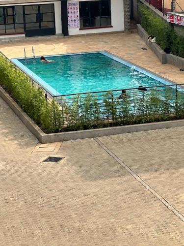 a swimming pool with two people swimming in it at The LUX in Nairobi