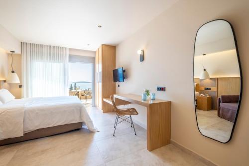 a hotel room with a bed and a mirror at ELIXIA in Tolo