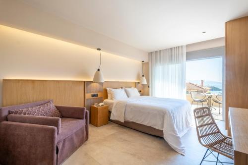 a hotel room with a bed and a couch at ELIXIA in Tolo
