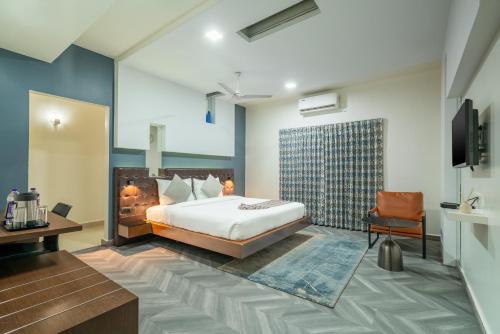una stanza d'albergo con un letto e una sedia di Hotel Serenity La Vista a Hyderabad