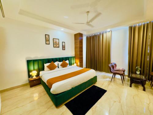 a bedroom with a large bed and a chair at Hotel La Casa, Amritsar #swimming pool #prime location #luxury rooms #best selling near golden temple in Amritsar