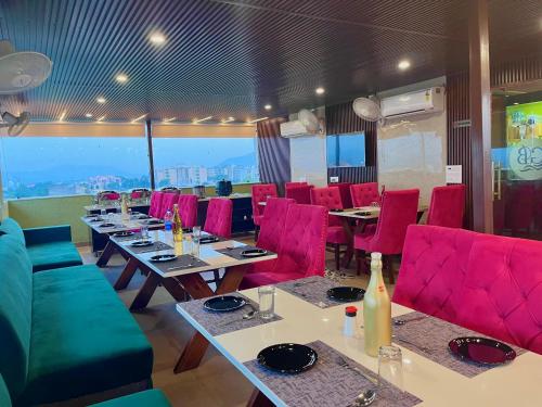 a dining room with tables and red chairs at Hotel La Casa, Amritsar #swimming pool #prime location #luxury rooms #best selling near golden temple in Amritsar