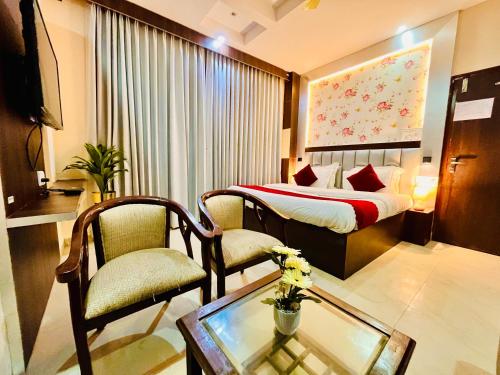 a hotel room with a bed and a table and chairs at Hotel La Casa, Amritsar #swimming pool #prime location #luxury rooms #best selling near golden temple in Amritsar