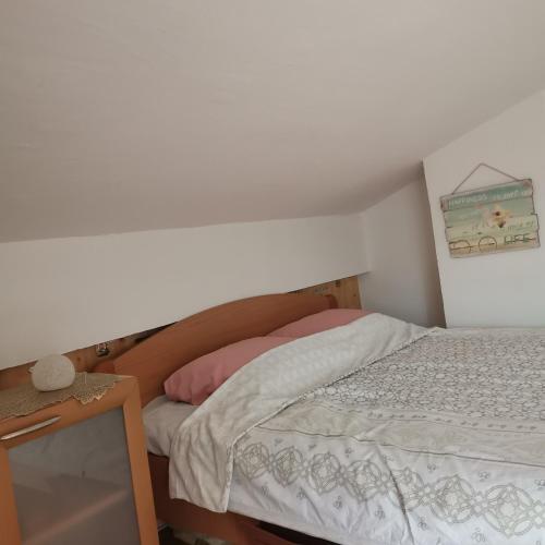 a small bedroom with a bed with a white bedspread at Zenith Center Apartment in Ohrid