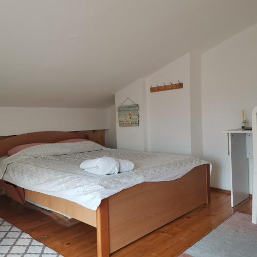 a bedroom with a bed with a white mattress at Zenith Center Apartment in Ohrid