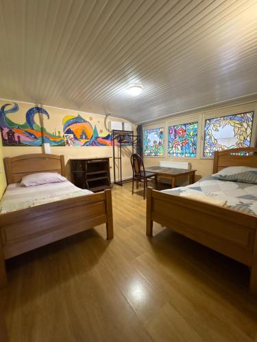 two beds in a room with stained glass windows at Foxy Forest in Tbilisi City