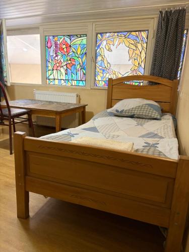 a bedroom with a bed and stained glass windows at Foxy Forest in Tbilisi City