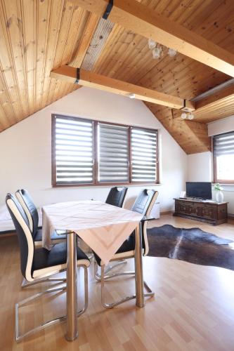a dining room with a table and chairs at Green Seeblick Hotel am See in Obermaubach