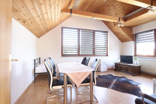 a dining room with a table and chairs at Green Seeblick Hotel am See in Obermaubach