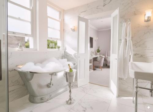 a bathroom with a tub and a sink at Bathen House Boutique Hotel in Bath