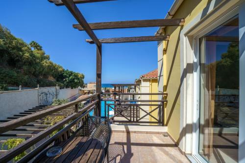 a balcony with a view of the ocean at Porto Kalamaki Hotel in Kalamaki Chanion