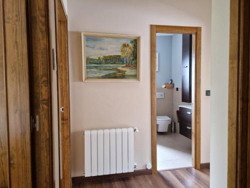 a bathroom with a painting on the wall and a radiator at "La Casa del Pueblo" - La Vera - AT-CC-00451 in Viandar de la Vera