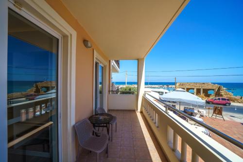 a balcony with a view of the ocean at Porto Kalamaki Hotel in Kalamaki Chanion