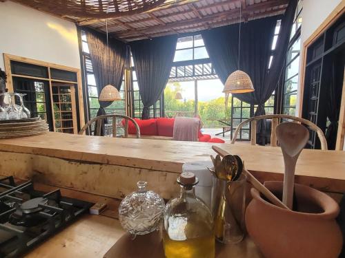 a kitchen with a counter with a stove and a table at DesertDewEstate in Nanyuki