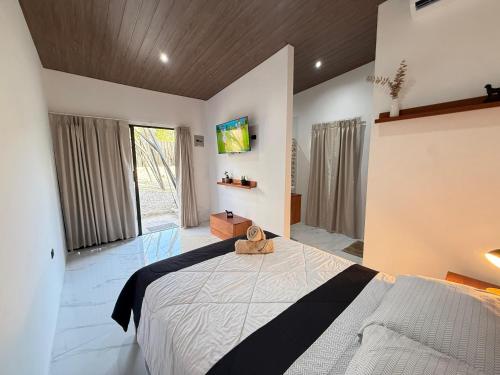 a bedroom with a large bed and a large window at Tena Tower House TTH in Tena