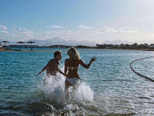 a man and a woman playing in the water at Club Paradisio El Gouna Red Sea in Hurghada