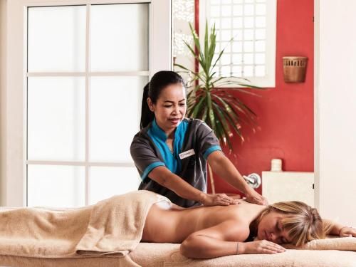 a woman getting a massage from a therapist at Club Paradisio El Gouna Red Sea in Hurghada