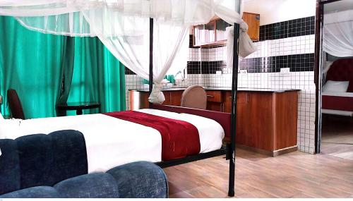 a bedroom with a bed with a canopy at Toque & GN Apartment in Nairobi
