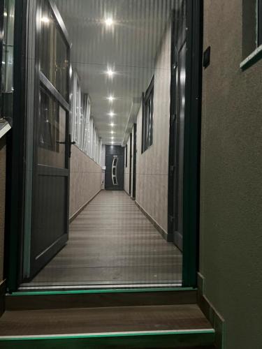 an empty hallway in a building with a long corridor at Ema, Asja, Eda Apartments in Zenica