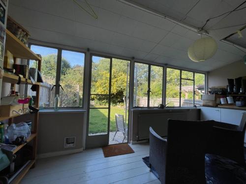 a kitchen with large windows and a view of a yard at Townhouse 30 mins from central London in Sevenoaks in Sevenoaks