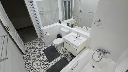a white bathroom with a toilet and a sink at A22SelborneGolfEstatePennington in Pennington