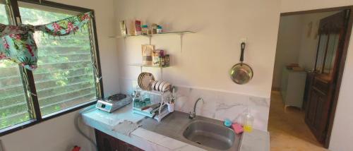 a kitchen with a sink and a window at Secret Thai Peace No1 in Thongsala