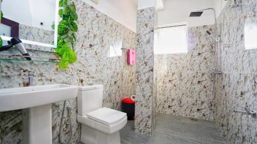 a bathroom with a toilet and a sink at Sun Leaf Lake in Dambulla
