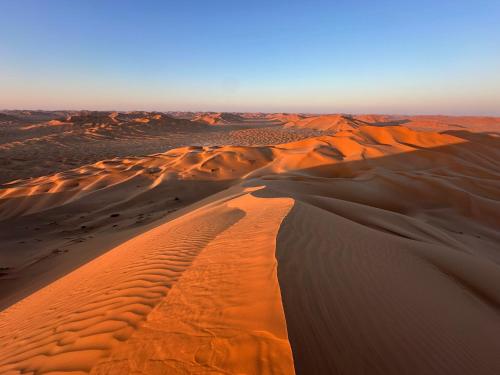 an aerial view of a desert with sand dunes at AArabian Sand Camp Empty Quater Salalah Oman in Fasad