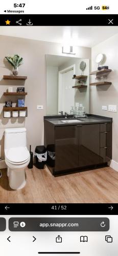 a bathroom with a sink and a toilet and a mirror at Janna hospitality in San Diego