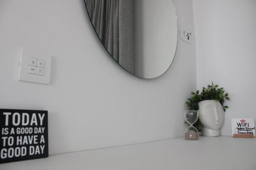 a mirror on a wall next to a bathroom at LuxApart74 l Comfy & Minimal Stay in Ierapetra in Ierápetra