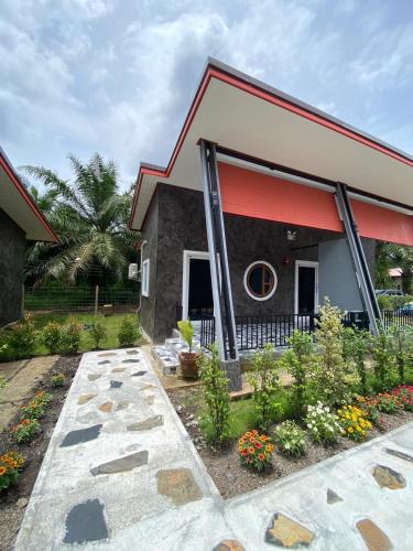 a house with a red roof at Khaosok Foresta Resort in Phanom