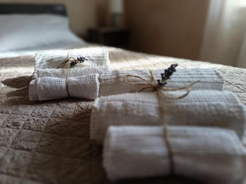 two towels are sitting on top of a bed at Villa Piccolomini in Siena