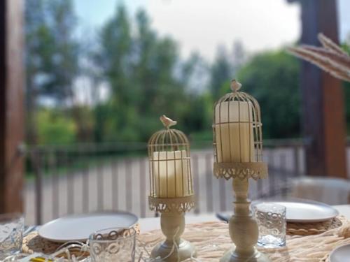 two birds in birdcage candles on a table at Villa Piccolomini in Siena