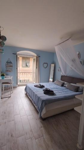 a bedroom with a bed with a mosquito net at Ca' Azzurra in Albenga