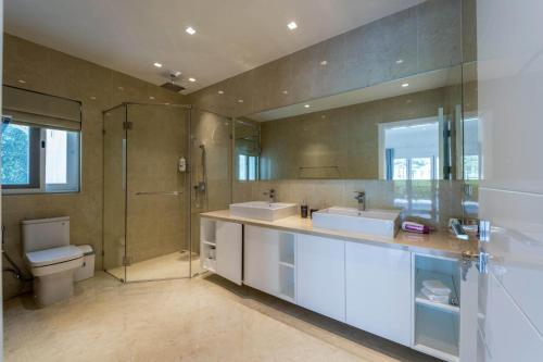 a bathroom with two sinks and a shower and a toilet at Nice 3BR with Golf Course View - BMG3 in Hua Hin